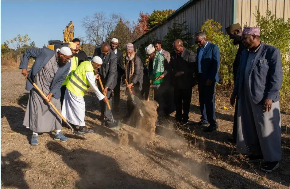 Community leaders turning the first earth at the October 2024 groundbreaking