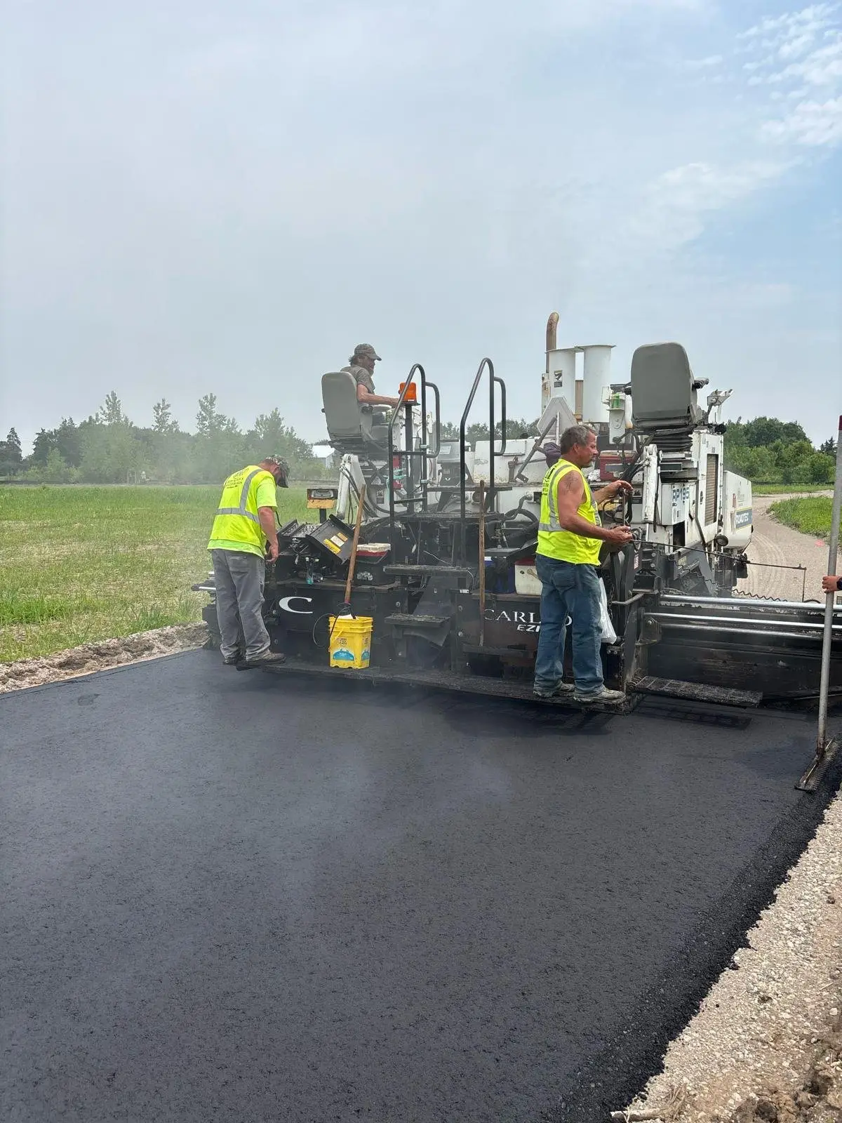 Crew paving the internal cemetery roads